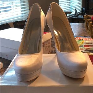 White heels with rhinestones on the side.